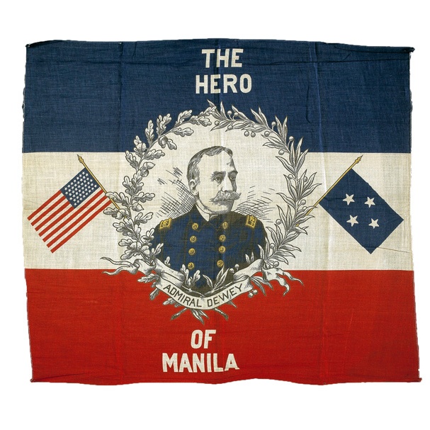 A canvas flag colored blue, white, and red, with a portrait of Admiral Dewey in the center